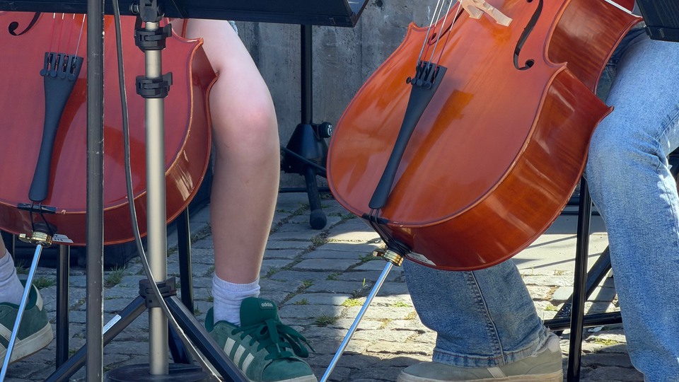 Två personer spelar cello. Foto. 
