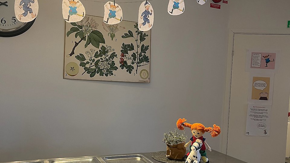 Skolmatsal med en Pippi-docka som vilar på ett bord. Foto